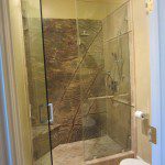 Frameless shower enclosure