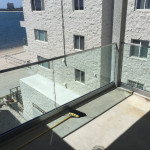 Glass Railing Set In Silver Powder Coat Base With Low Profile Stainless Steel Top Rail